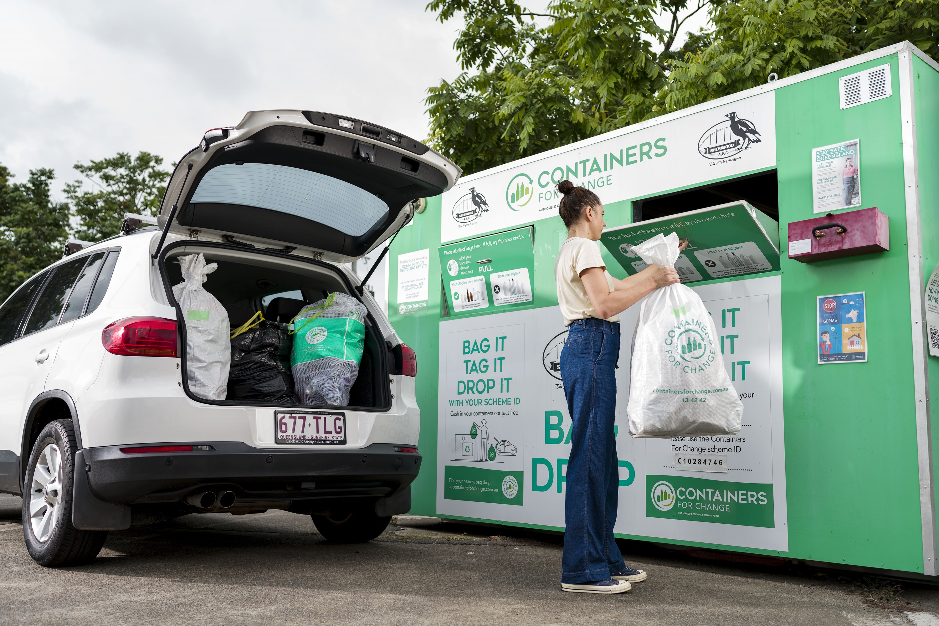 Person using bag drop Containers for Change